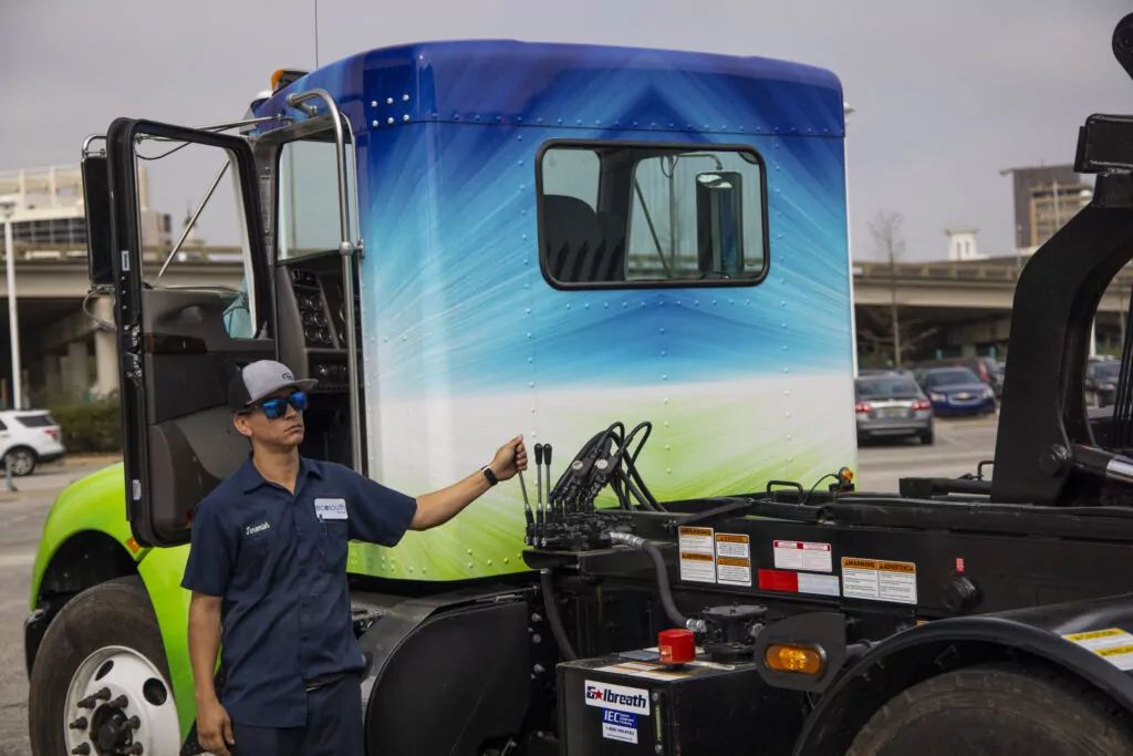 Man operating a lift on a truck.